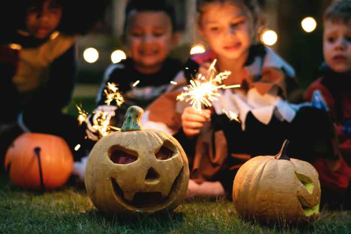 children holding firecrackers outdoors